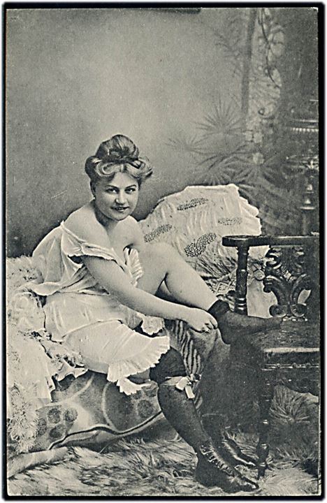 Erotisk postkort. Kvinde ved at tage knæstrømper på. Serie 501, no. 3. 