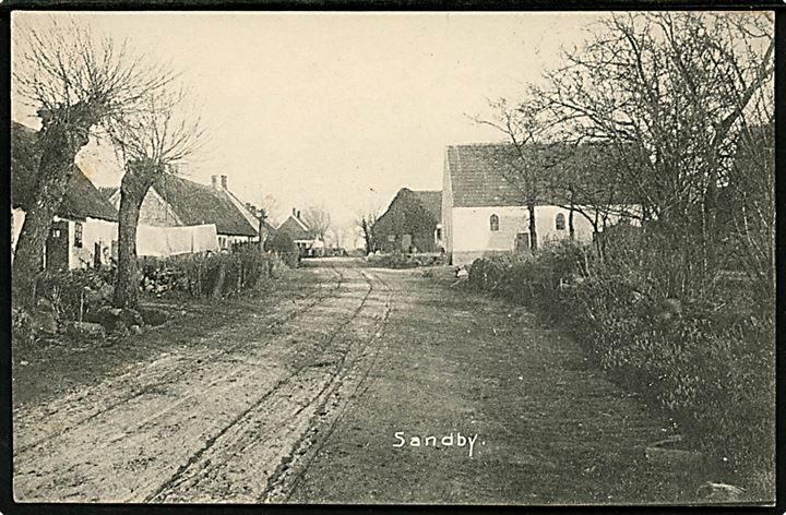 Sandby ved Holbæk. Gadeparti. J. P. K. P. Mørkøv no. 5550. Frankeret med 5 øre Chr. IX annulleret med stjernestempel SANDBY og sidestemplet bureau Nykjøbing S. - Holbæk T.8 d. 11.7.1906 til København.