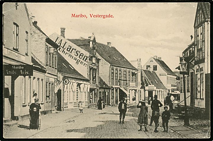 Maribo. Vestergade med, Amts Avisens konto og J.A. Larsens Uhrmager mf. W. & M. no. 566. 