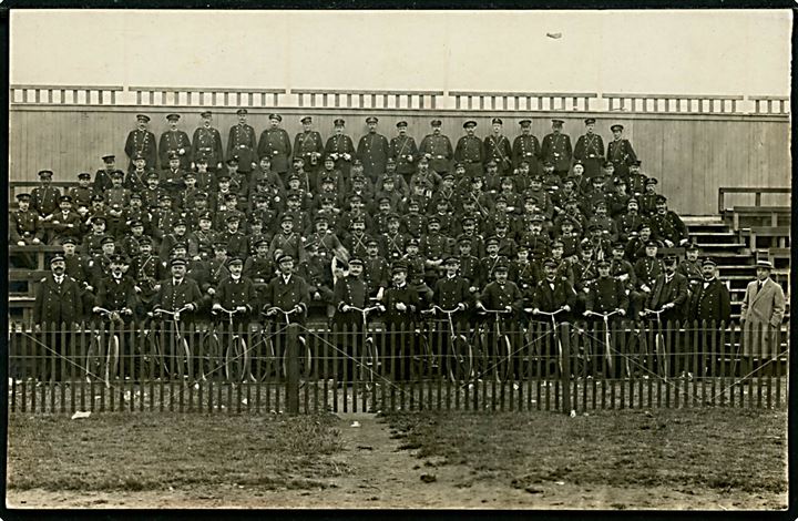 Uniformerede mænd på tribune. Muligvis frivilligt korps. Fotokort fremstillet i Danmark u/no.